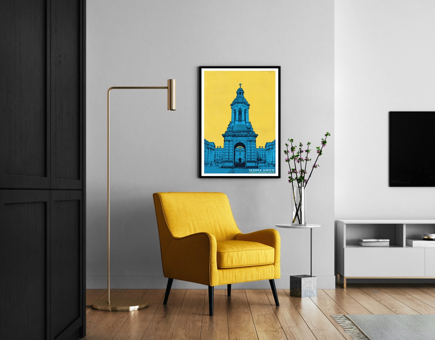 A sitting room with a yellow armchair, floor lamp and bright print of the Trinity Campinile on the wall.